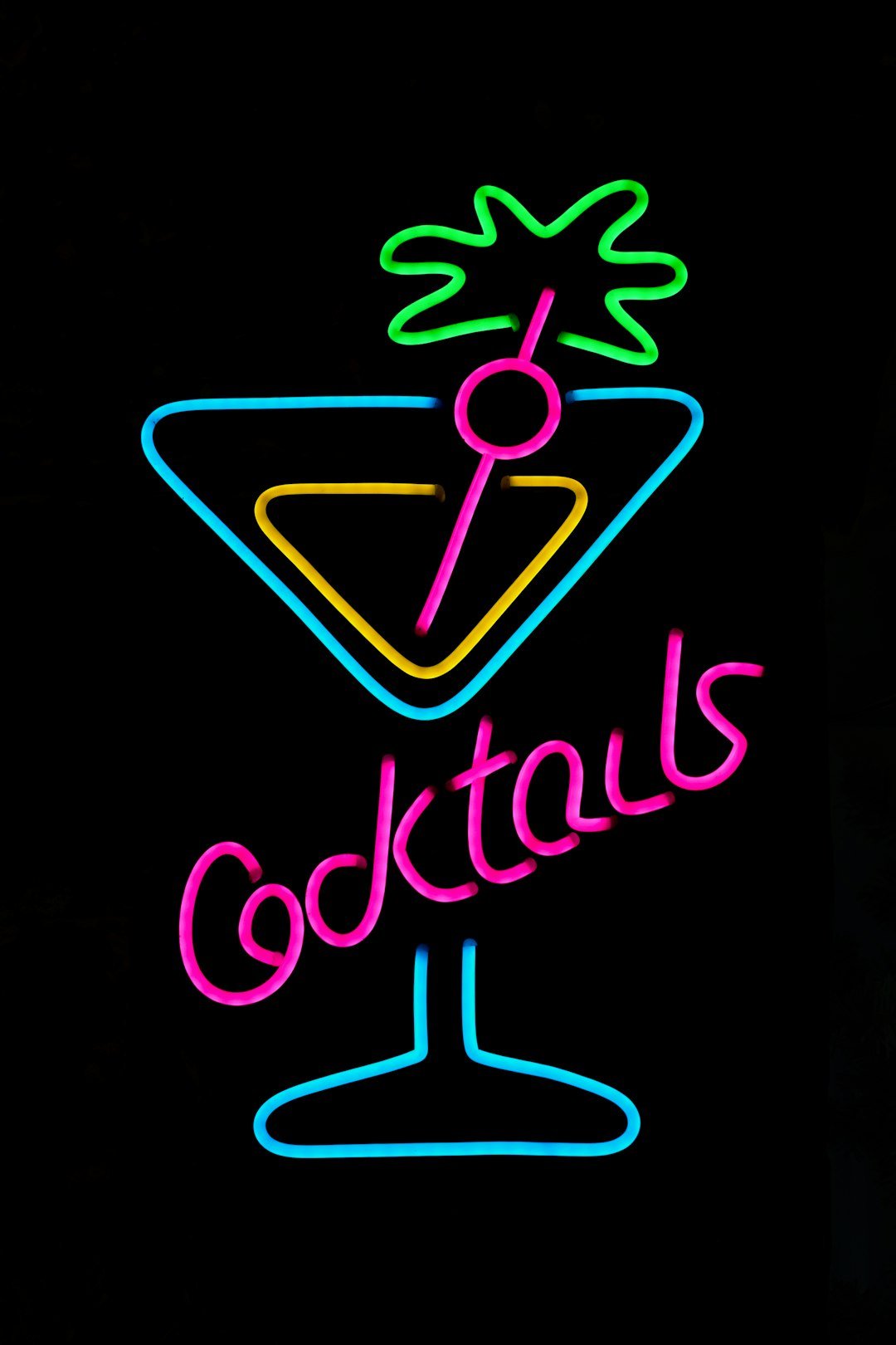 A neon sign advertising cocktails